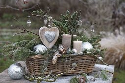 Christmas arrangement in basket with branches of Juniperus