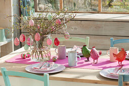 Easter table in the winter garden, bouquet of branches of Amelanchier