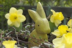 Easter wreath with daffodils and wooden Easter bunny