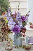 Violet bouquet in old zinc milk jug, dahlia, gladiolus