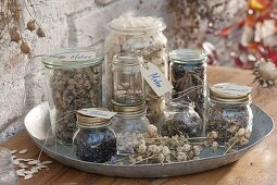 Jars with collected perennials, summer flowers and vegetables seeds