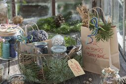 Wire basket with cones, abies branches, jars with seeds