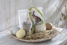 Flat wooden bowl with hay as Easter basket