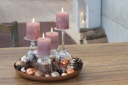 Unusual Advent decoration with candles on inverted glasses