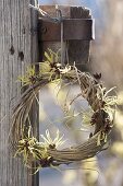 Wreath of winded grass, decorated with fragrant flowers