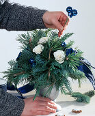 Tying a Christmas bouquet, putting balls in a bouquet