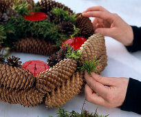 Straw blank as advent wreath pasted with cones - fill gaps with moss