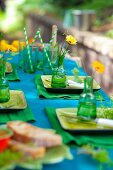 Table festively set in shades of blue and green outside