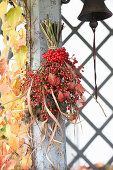 Bouquet of viburnum berries, rose hips, reeds and raspberry leaves