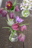Snakes' head fritillaries, pasque flowers and lady's smock in small vases