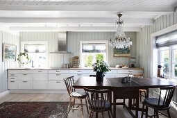 Dining area in white country-house kitchen
