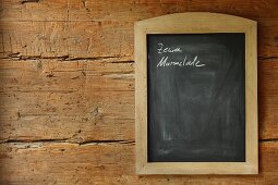 Notes on framed chalkboard on rustic wooden wall
