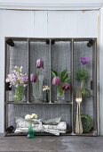 Various spring flowers arranged in upright metal cutlery drawers