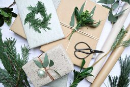 Decorating Christmas presents with twigs and leaves