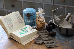 Open cookery book, biscuits and vintage kitchen utensils