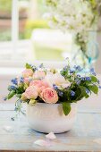 Low spring arrangement of forget-me-nots and roses