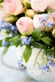 Detail of arrangement of forget-me-nots and roses