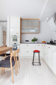 Scandinavian-style wooden chairs and dining table in kitchen