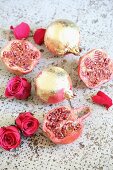 Rosenblüten und vergoldete Granatäpfel