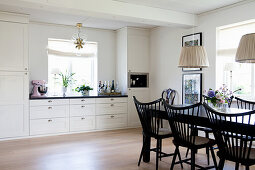 Black dining set in white country-house kitchen
