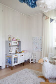 Play kitchen and striped wallpaper in child's bedroom