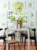 Gallery of vegetable pictures in white frames in dining area