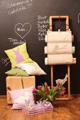 Hand-sewn Easter cushions, magazine rack with wooden frame, vase of tulips and chalkboard wall with messages in chalk