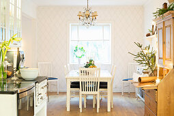 Festively decorated kitchen-dining room with diamond-patterned wallpaper