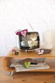Mouse-shaped dusters hand-sewn from fleece and cotton fabrics on TV cabinet