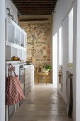 White shelves and mosaic wall in narrow kitchen