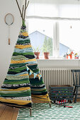 Teepee handmade from strips of fabric in child's bedroom