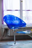 Transparent blue plastic shell chair