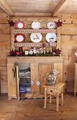 Rustic wooden cabinet and plate rack in wooden cabin