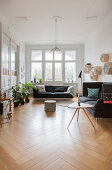 Sofa, coffee table and houseplants in period apartment