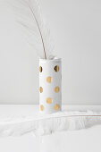 Vase hand-made from can using golden adhesive spots