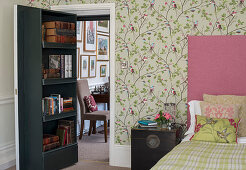 Bookcase on concealed door leading into romantic bedroom