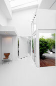 White, modern architect-designed house with interior conservatory