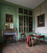 Open fireplace and green wood panelling in historical library