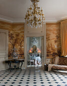 View from historical parlour with toile de jouy wallpaper into dining room