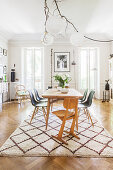 Bright dining room in natural shades in period apartment with floor-to-ceiling windows
