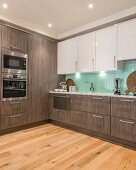 Elegant fitted kitchen with glass splashback