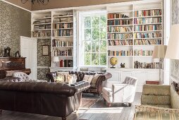 Pair of leather sofas in library with open shelving