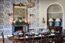 Set table in elegant dining room with toile de jouy wallpaper
