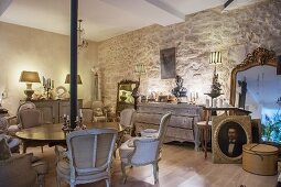 Antique furnishings in renovated period apartment with stone wall