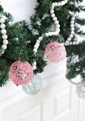 Christmas baubles hand-made from cord and hung from garland