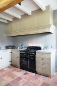 Simple country-house kitchen in natural shades with terracotta floor tiles