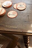 Round beer mats on oak table
