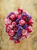 Bouquet of roses and sea lavender wrapped in brown paper