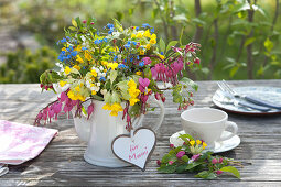 Colorful spring bouquet in coffee pot,