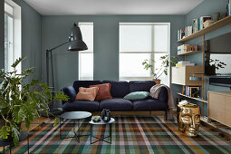Tartan rug in living room with blue walls